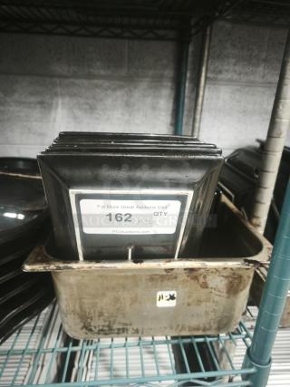 6"x8" rectangular black porcelain plates stacked in a metal container. Label reads "QTY 25, PCIauctions.com, 162."