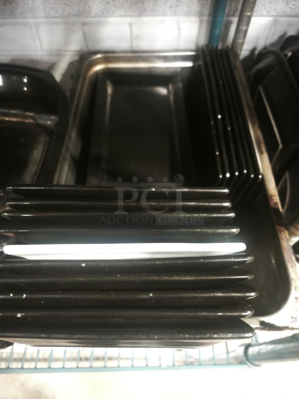 6"x8" rectangular black porcelain plates stacked, glossy finish, excellent condition. Suitable for dining or decorative use.