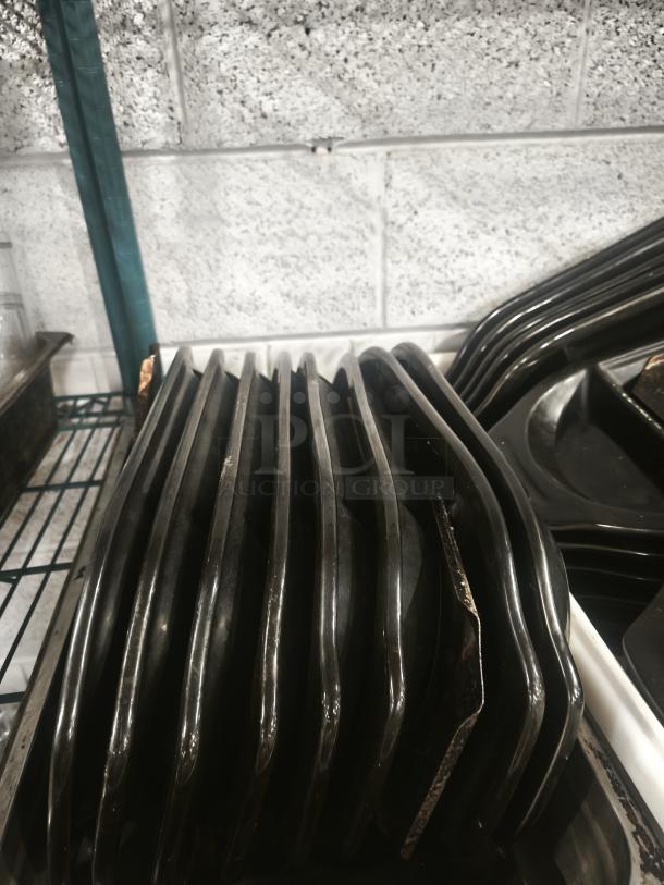 Black stone serving platters from Black Rock Bar and Grill, stacked, in good condition.