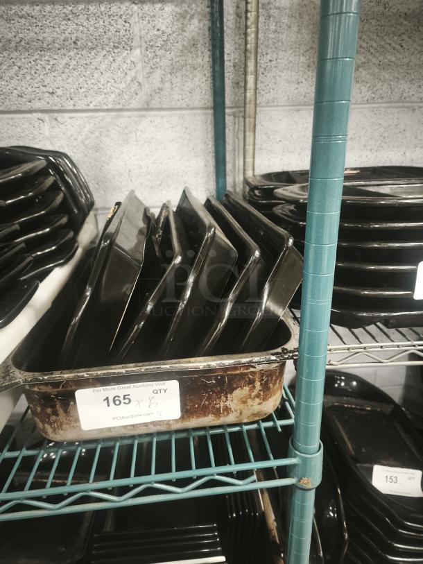 Black Rock Bar and Grill hot stone serving platters on shelves, visible signs of wear, auction tag reading "165 x 6."