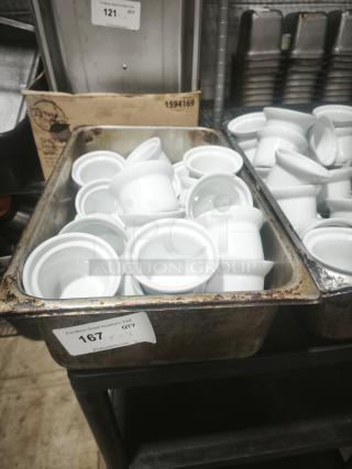 A batch of Aluma White Medium Porcelain Pot Pie Dishes, shown in a metal container. Clean, pristine condition. Auction tag indicates quantity of 26.