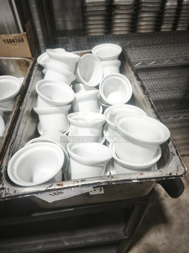 Aluma medium porcelain pot pie dishes, white, stacked in a cart, pristine condition, suitable for baking or serving.