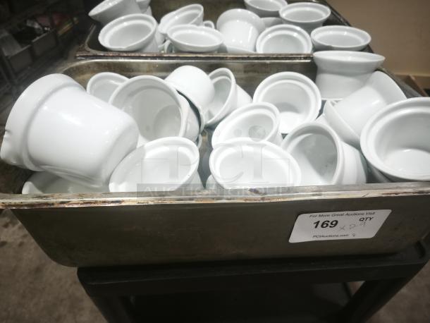 White porcelain pot pie dishes, medium size, grouped in a metal bin. Condition looks good. Auction lot label "169."