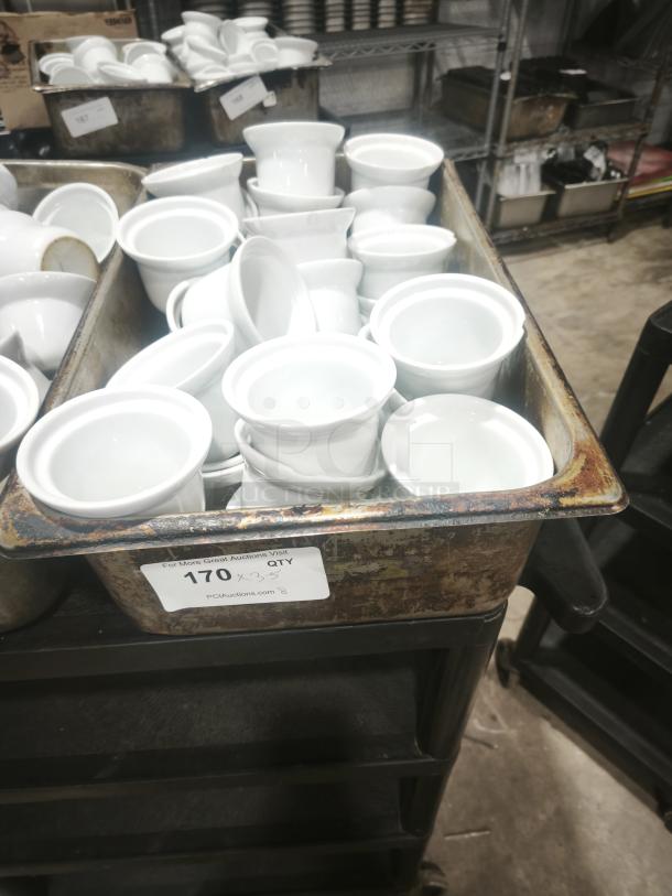 Group of Aluma White Medium Porcelain Pot Pie Dishes stacked in a large rusted tray; quantity labeled as 170.