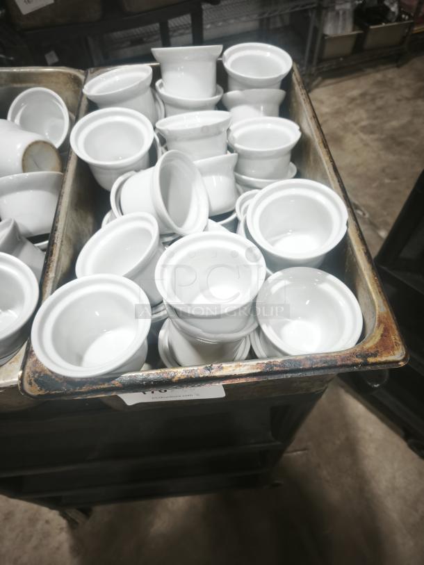 Stack of Aluma White Medium Porcelain Pot Pie Dishes in a metal tray, showing smooth finish and uniform design.