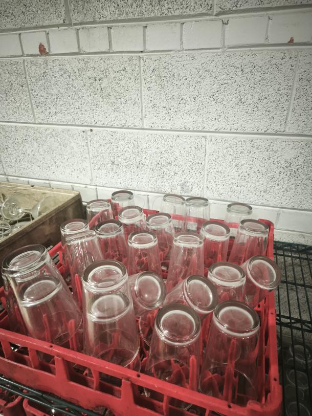 Vintage restaurant glass tumblers in a red rack, excellent condition, clear glass, classic design, ideal for collectors.