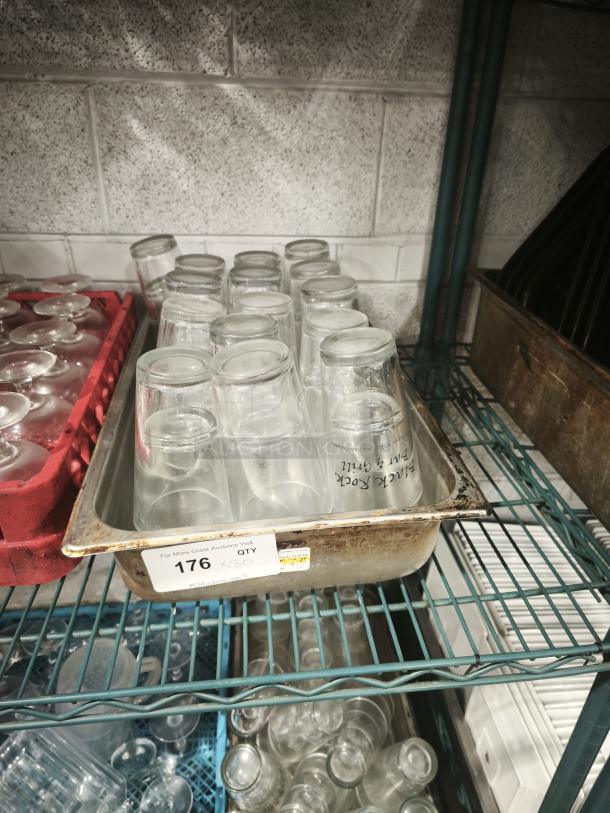 Vintage restaurant glass tumblers in a metal tray, clear design, showing some wear. Auction tag reads "176 QTY 30".