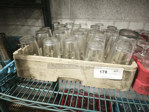 Vintage glass tumblers in a crate, showing 24 pieces. Used condition, stored on shelving. Auction label: "178 x 24".