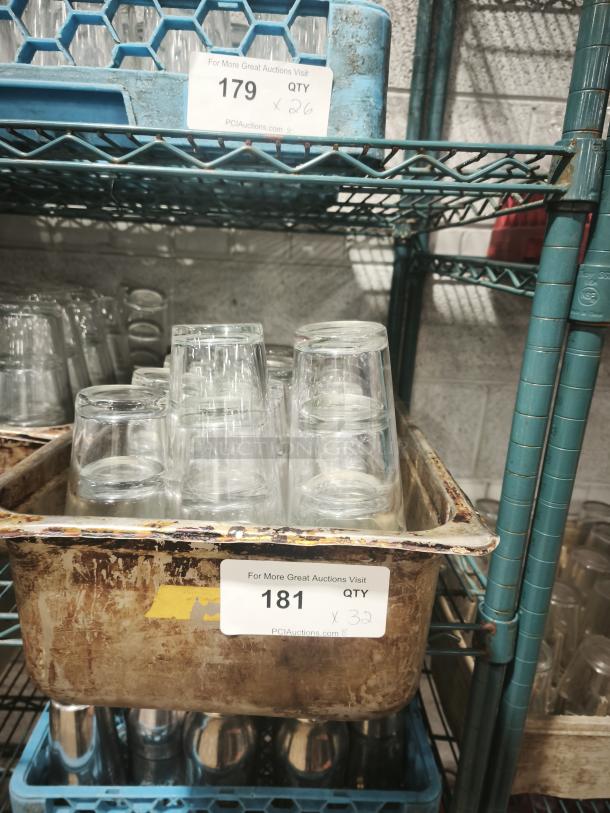 Vintage restaurant glass tumblers in a rusted metal tub, quantity 32. Ideal for collectors or retro-themed settings.