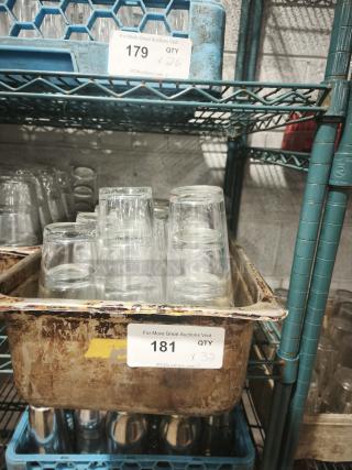 Vintage restaurant glass tumblers in a rusted metal tub, quantity 32. Ideal for collectors or retro-themed settings.
