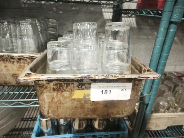 Vintage restaurant glass tumblers in a weathered metal tray, quantity label states 181.
