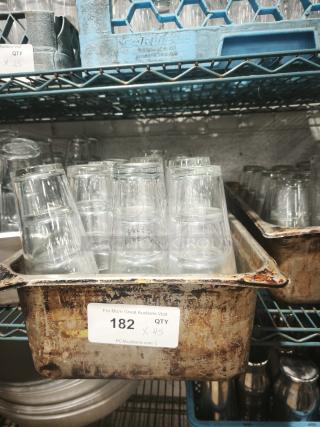 Vintage glass tumblers in industrial tray, quantity 45. Some wear on tray, clear glass, perfect for restaurant or bar use.