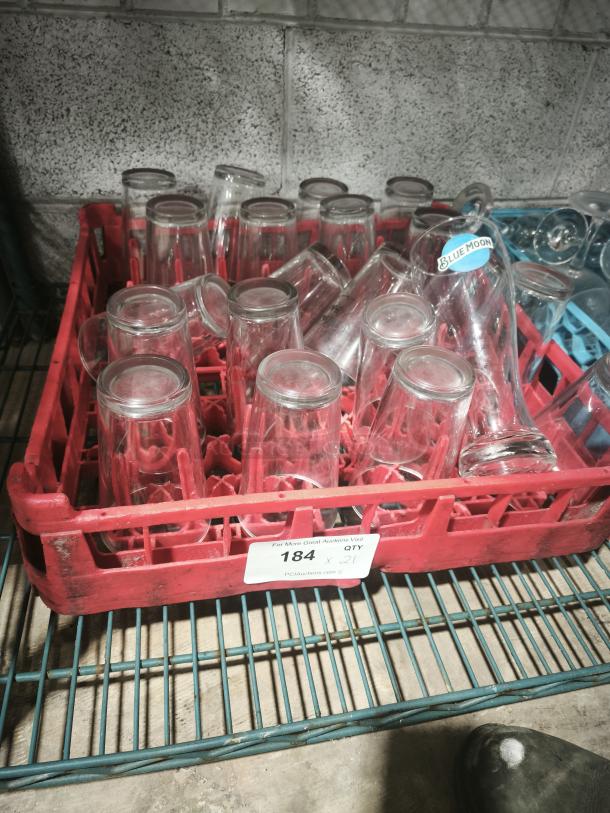 Vintage glass tumblers in red rack, various sizes, clear glass, labeled crate. Suitable for restaurant use. Quantity 21.