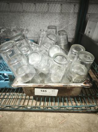 Vintage glass tumblers in a metal tray, quantity 37, used, restaurant-style, clear glass with cylindrical shape.