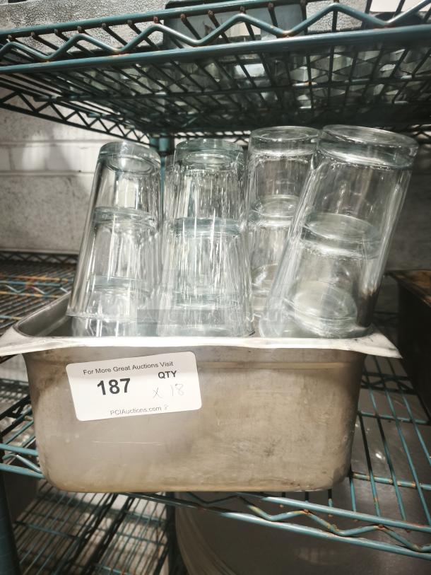 Vintage glass tumblers displayed in a metal tray. Includes 18 pieces. Ideal for restaurant use, showcasing retro charm.