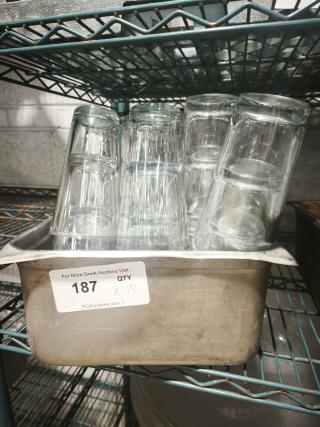 Vintage glass tumblers displayed in a metal tray. Includes 18 pieces. Ideal for restaurant use, showcasing retro charm.