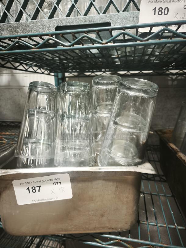 Vintage glass tumblers, set of 18, clear glass, stacked in a metal tray. Numbered tag "187" visible.