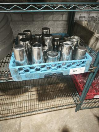 Vintage stainless steel cocktail shakers in a blue crate, reflective finish, good condition, stacked on a metal shelf.