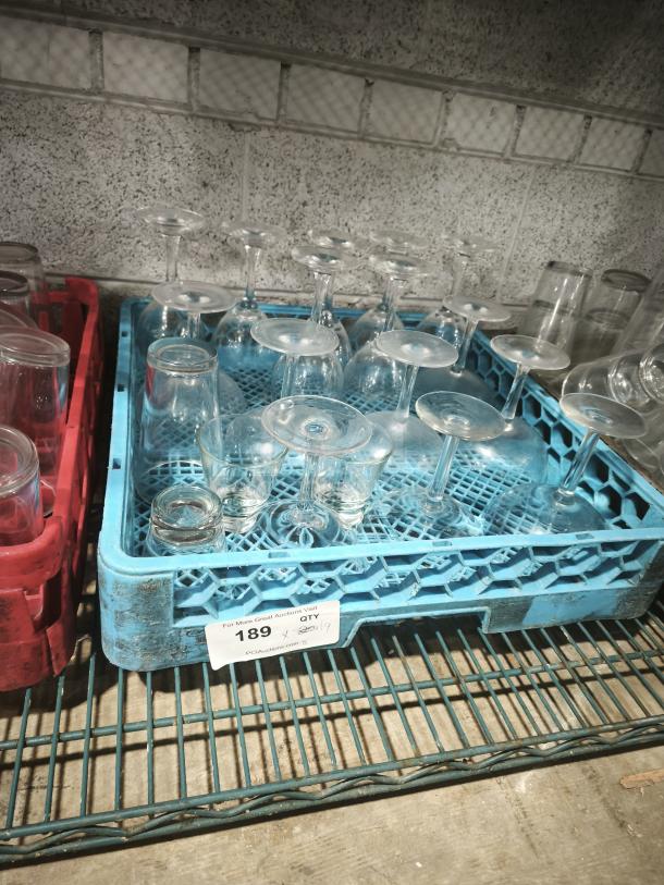 Assorted wine glasses in blue and red crates on a shelf. Label reads "189" with quantity details.