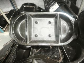 Black stone serving platter for hot meals, featuring dual sections and slight wear, from Black Rock Bar & Grill.