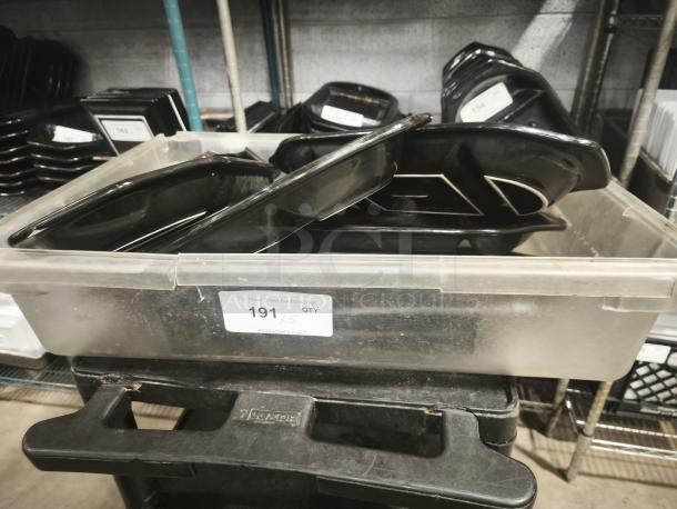 Black stone serving platters from Black Rock Bar and Grill, in a plastic bin labeled "191," used condition.