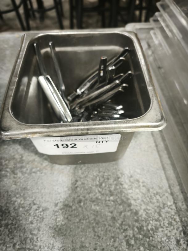 Stainless steel crab crackers and tools set in a metal bin, labeled "192 QTY" for auction. Ideal for seafood preparation.