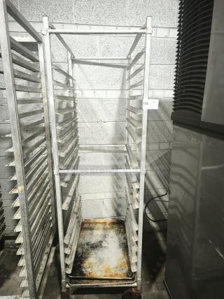 Aluminum bakers rack with multiple shelves, used condition, missing cover, item tag labeled "198" visible.