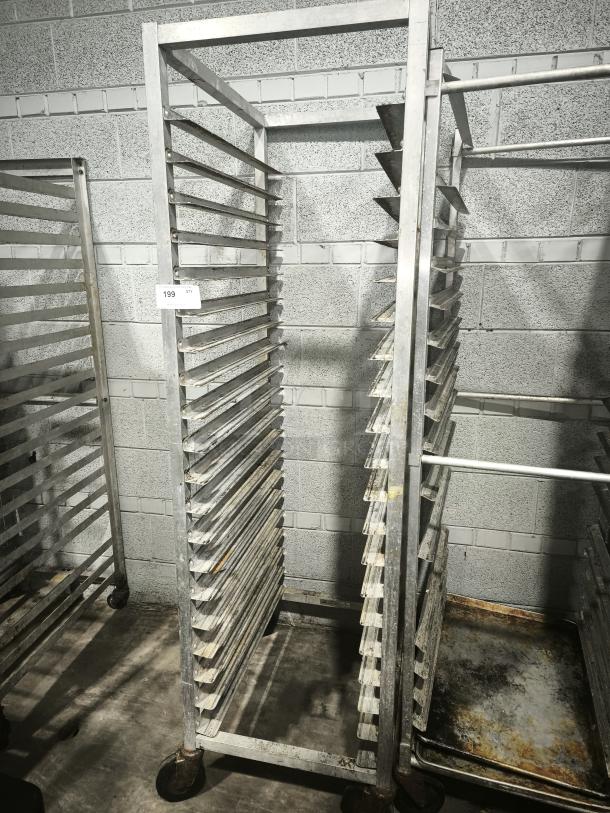 Aluminum bakers rack with multiple shelves, sturdy wheels, and visible wear. Ideal for kitchen or bakery use. Catalog number 199 displayed.