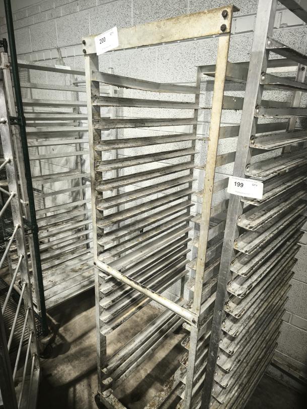 Aluminum bakers rack with multiple shelves, visible wear and rust. Label marked "200 QTY" indicates inventory number.