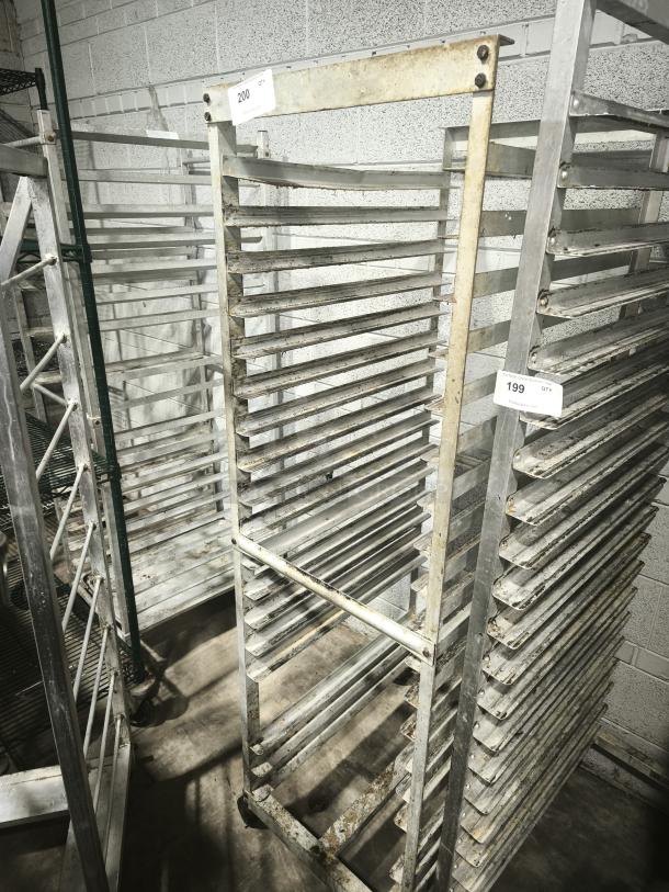 Aluminum bakers rack with multiple shelves, signs of wear, and tags labeled "200" and "199."