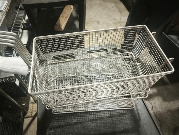 Brand new commercial wired mesh fry basket with front hook, features a black non-slip grip handle.