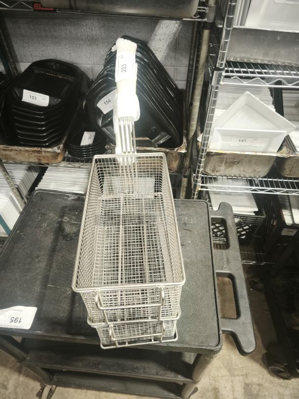 Brand new commercial wired mesh fry basket with front hook, black non-slip grip handle; auction tag number 203 visible.