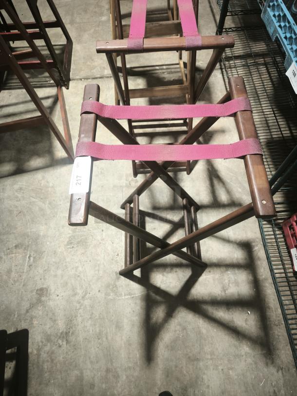 Folding wooden tray stand, 32-1/4" high, mahogany finish, red straps. Excellent condition with tag marked "217."
