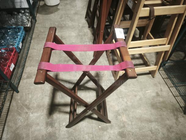 Folding wooden tray stand in mahogany, 32-1/4" high, with red fabric straps, in good condition.
