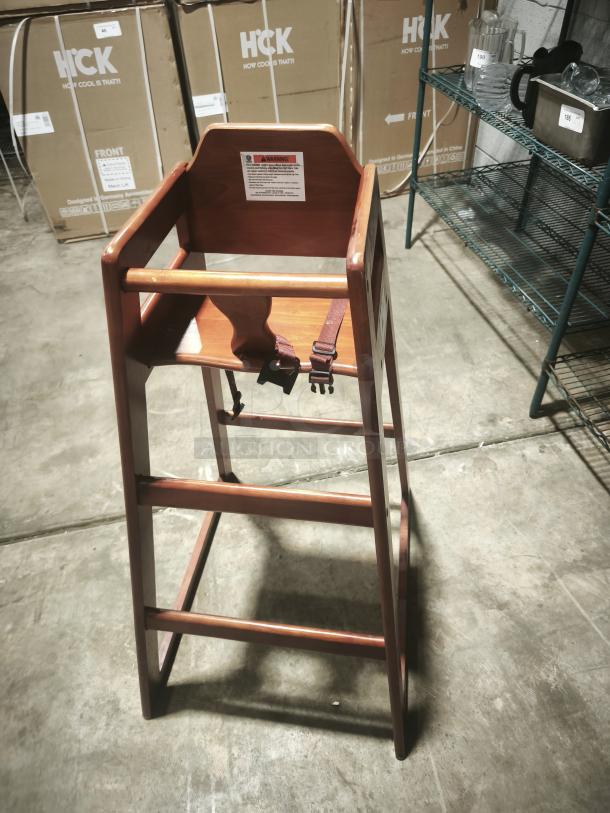 Wood bar-height high chair with safety straps and a label, ideal for babies and toddlers. Durable and ready-to-assemble.