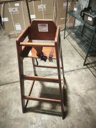 Wooden bar height high chair for babies, durable, ready-to-assemble, with safety strap and footrest, like new condition.
