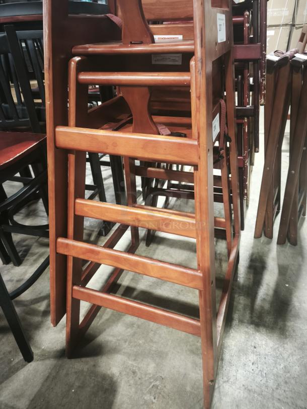 Wooden bar-height high chair for babies and toddlers, stackable, ready-to-assemble, durable construction with visible labels.