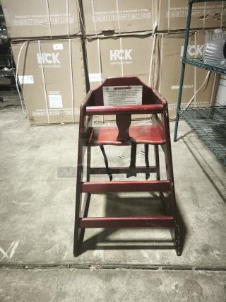 CHH-103 29 3/4" stackable wood high chair with waist strap, showing minor wear, sturdy design, and safety label.