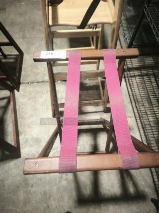 Folding wooden tray stand, 32-1/4" high, with sturdy red straps. Marked with "216" tag. In good condition.