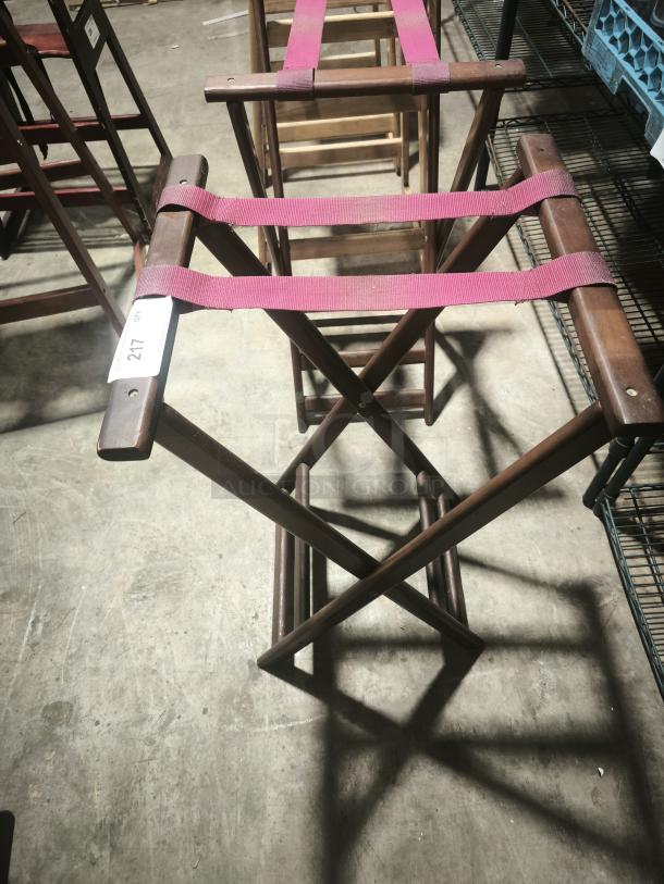 Folding wooden tray stand, 32-1/4" high, with pink fabric straps. Visible tag labeled "217". Good condition.