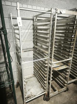 Aluminum bakers rack with multiple shelves, used condition, rolling casters, item tag number 218 visible.