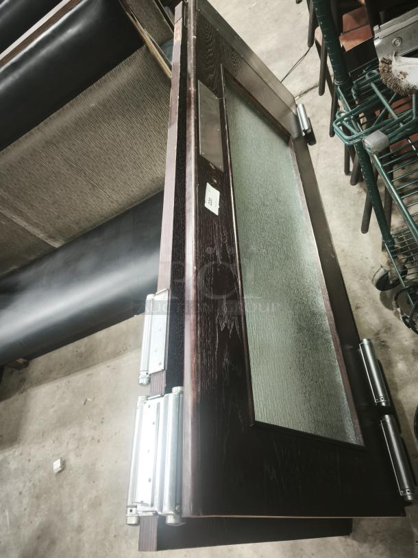 Solid wood double door with glass sliding panel, grill design, modern look. Features metal hinges. Dark finish, new condition.