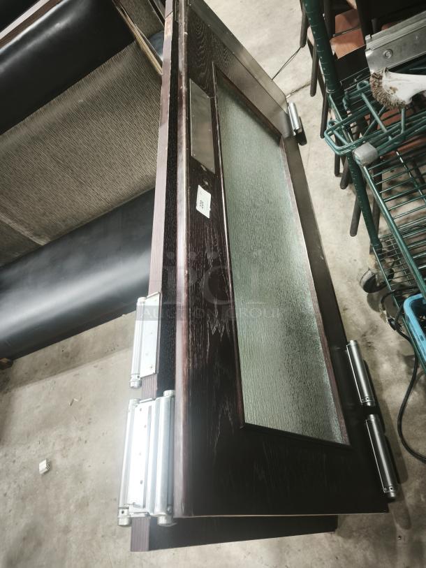 Solid wood double door, interior sliding with glass and grill design, features metal hinges, modern style, uninstalled condition.