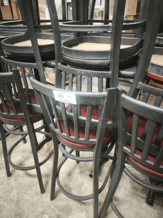 Black School House Back Metal Dining Chairs with mahogany wood seats, stacked in storage; tag indicates quantity "228."