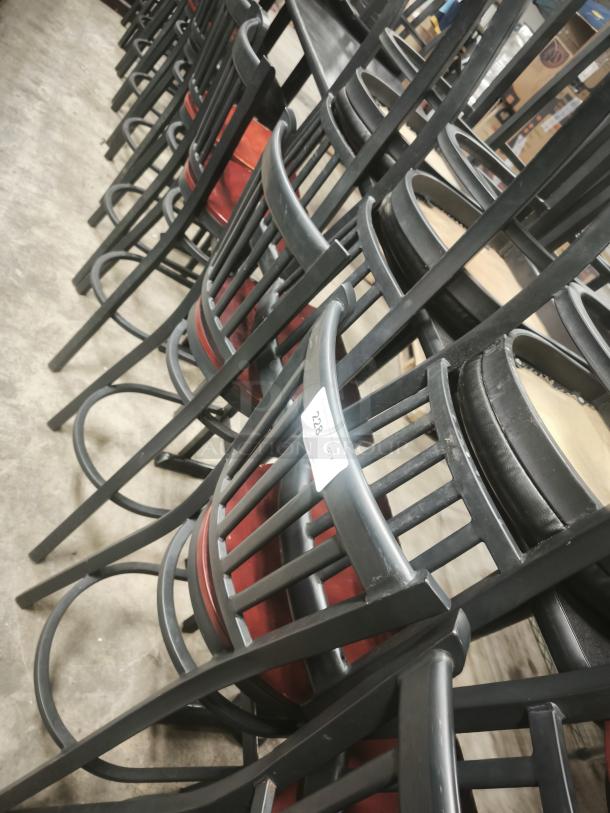 Black School House back metal dining chairs with mahogany wood seats, stacked. Item tag shows number 228.