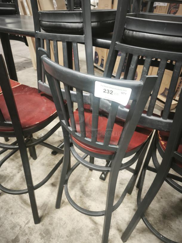 Metal dining chair with a mahogany wood seat, black frame, slat back design. Auction label "232" attached. Good condition.