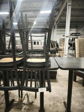 Metal dining chair with slatted back and mahogany wood seat, stacked on table. Good condition with visible tag reading "234."