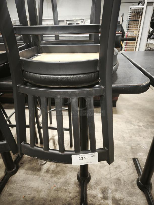 Metal dining chair with mahogany wood seat, black frame. Good condition. Visible auction tag reads "234." Ideal for modern decor.