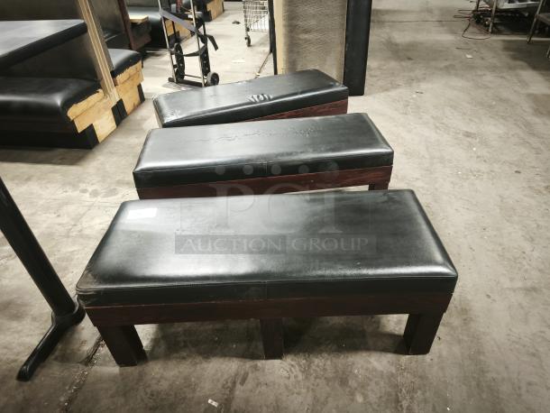 Leather upholstered RACK Tuscany Storage Bench with high-density foam, visible wear marks, and a label.