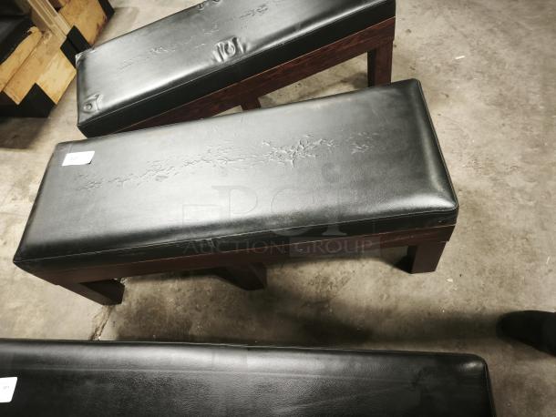Tuscany leather storage bench with high-density foam, black upholstery, visible wear with marks; auction tag 232 attached.